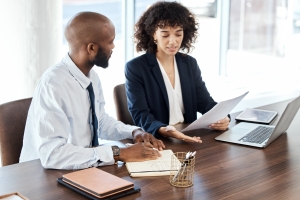 Meeting, business and black people with documents for accounting budget, planning or company portfolio review. Teamwork, financial advisor and analysis of ideas, investment report or legal consulting.