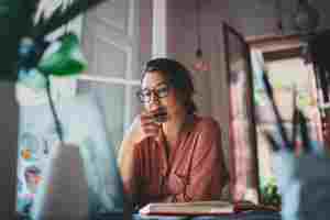 Young businesswoman thinking about something while sitting front