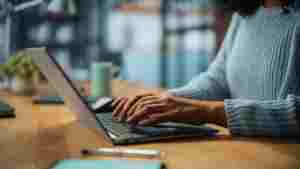 Close Up on Hands of a Female Specialist Working on Laptop Compu